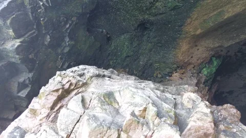 View looking down into dark sea cave opening Ballestas Islands Peru Video stock 348781260