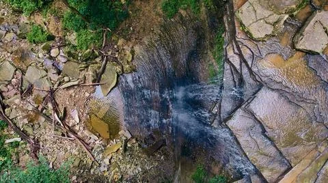 View looking down at edge of waterfall into gorge 写真素材