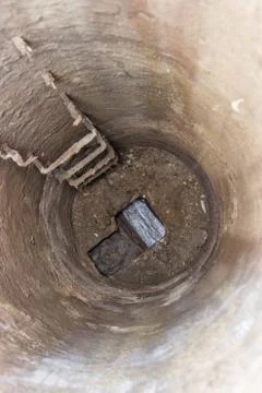 View looking down into an open manhole Stock Photos