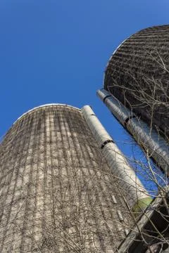 View looking up the face of two old concrete silos against a blue sky Stock Photos