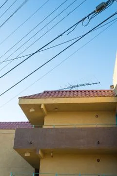 View looking up at a generic stucco and terracotta tile building Stock Photos