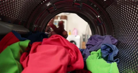 View looking from inside washing machine, man takes out laundry Stock Footage 222793382
