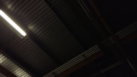 View looking up to large warehouse hangar structural roof metal beams &amp; Stock Footage 104642434