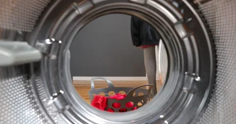 View Looking Out From Inside Washing Machine. Dirty clothes falls to a laundr Stock-Footage 152855773