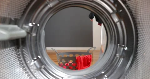 View Looking Out From Inside Washing Machine. Dirty clothes falls to a laundr Stock Footage 152855804