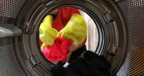 View Looking Out From Inside Washing Machine As Man Puts In Laundry Load Stock Footage 152857969