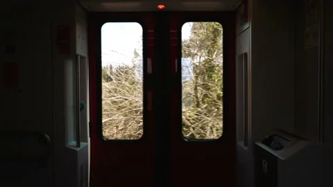 View Of Looking Out Of intercity Train Door As It Approaches Station Platform Stock Footage 180057558