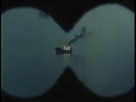 View looking through binoculars at black smoke coming from ship in the distan Stock Footage 260249175