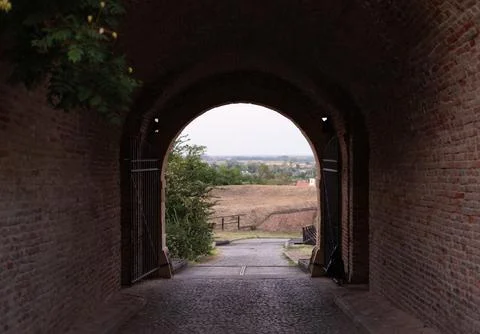 View looking through a dark brick archway at Petrovaradin Fortress Stock Photos