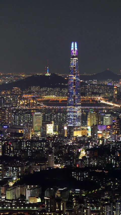View of Lotte World Tower with animated facade lights and nighttime Seoul Stock Footage 295057391