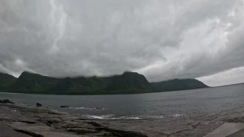 View of low clouds over Ersfjord mountains from Tungeneset coast in Senja Norway Stock-Footage 342059434