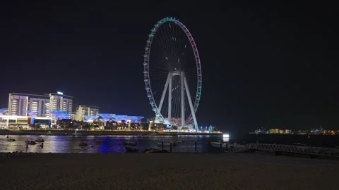 View of luminous Ain Dubai Ferris wheel and colorful neon illumination Stock Footage 331728474
