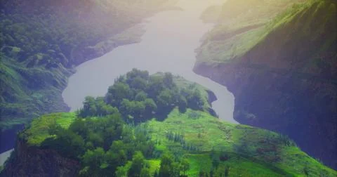 View of a lush river valley surrounded by steep green hills at sunset Stock-Illustration