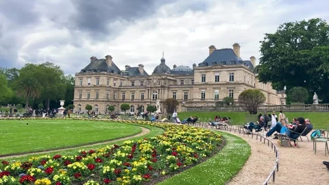  View of the Luxembourg Palace, spring Primula beds and tourists.  Video stock 311941234