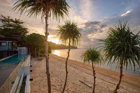 View from luxury villa at sunset, pool lighting, sun loungers for sunbathing 写真素材
