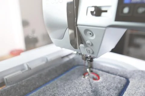 View on machine head of a modern sewing machine with embroidery unit Stock Photos