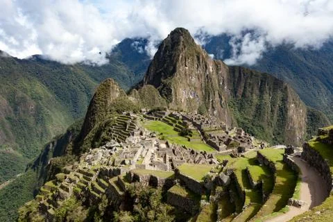 View of Machu Picchu, the sky in the clouds, Peru. Stock Photos
