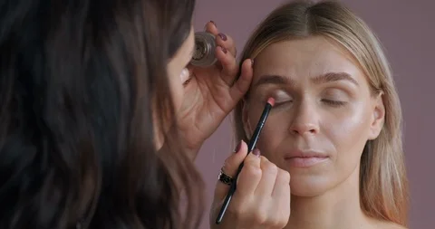 View of make-up artist’s hand applying eye shadow with special brush woman Stock Footage 120149553