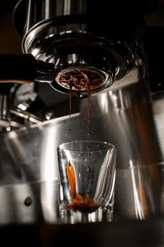 View of making espresso on coffee machine through portafilter from arabica Stock Photos