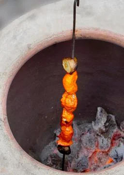 View of making mutton kababs or kebabs on coal fired arrangement Stock Photos