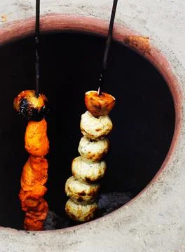 View of making mutton kababs or kebabs on coal fired arrangement Stock Photos