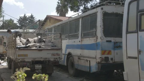 View of a man dropping rolled raw materials from a car Stock Footage 108476840