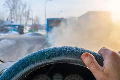 View of a man hand, the driver on the steering wheel inside the car Foto stock