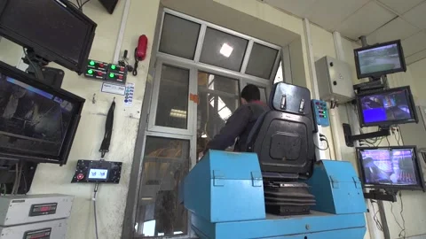 View of a man handling a grapple grabbing trash cans in a factory Stock Footage 158750516