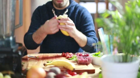 View of man hands peeling and cutting banana Stock Footage 59541387