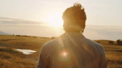 View of a man with his back against the horizon Stock Footage 79095396