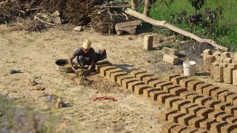 View of a man making handmade mud bricks in a rural field, Nepal. Video stock 335467291