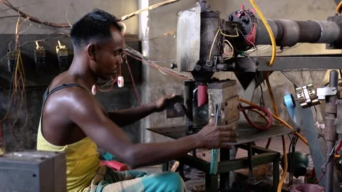 View of a man operating industrial machinery in Bogura, Bangladesh. Stock Footage 336425248