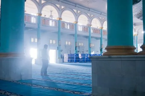 View of man performing prayer in the Blue Mosque of Sultan Ismail Mosque, Mua Stock Photos
