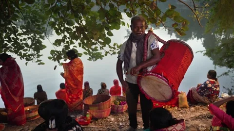 View of a man playing a traditional drum by a river, Bangladesh. 스톡 동영상 334988732