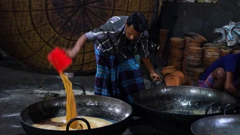 View of a man pouring milk into a large vat in Bogura, Bangladesh. Stock Footage 336425721