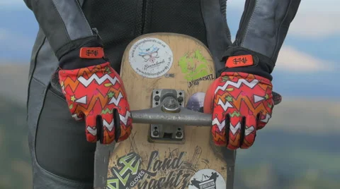 View of a man with red gloves holding a longboard on Transalpina Stock Footage 57785330