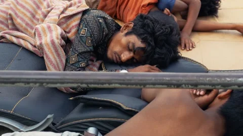 View of a man sleeping at Sadarghat river port, Bangladesh. 動画素材 335600421