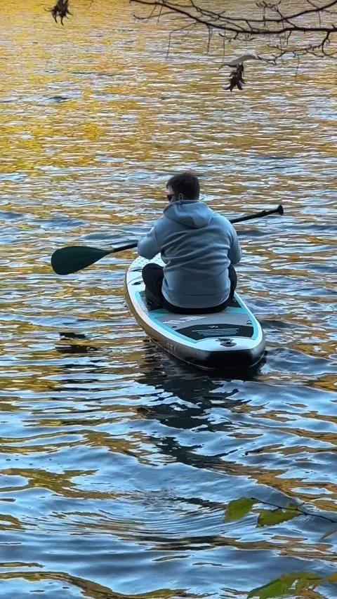 View of man on supboard in the middle of autumn lake Stock Footage 270050867