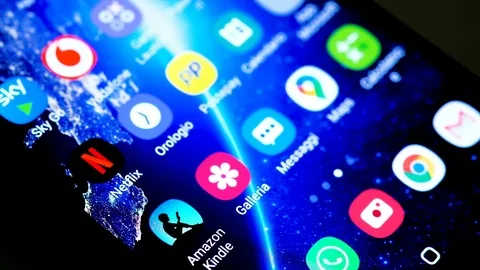 View of man tapping on a smartphone netflix app,digital video streaming platform Stock Footage 126583219