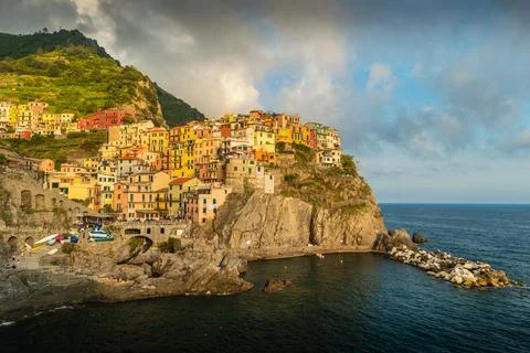 View of Manarola, Cinque Terre, La Spezia, Italy at sunrise with cliff sea Stock Photos