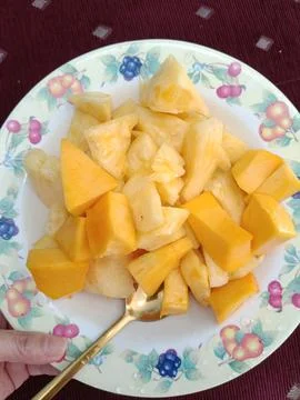 View of mango and pineapple on a plate Stock Photos