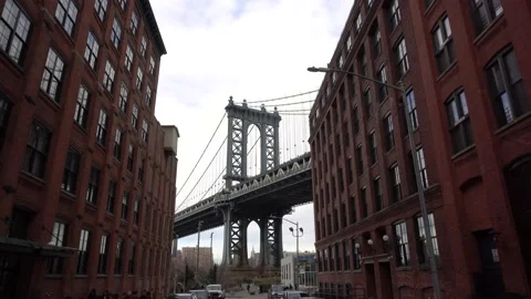 View of the Manhattan Bridge between buildings, NYC Stock Footage 166753253