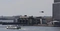 View of Manhattan Heliport New York City with Ferry Boat and Helicopter Flying 4k or 4k+ Resolution