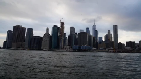  	View of Manhattan skyline from Brooklyn bridge waterfront. Time lapse. Stock Footage 101387275
