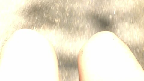 View to a man's angle legs while sit on the electric golf car in summer res.. Stock Footage 259788425