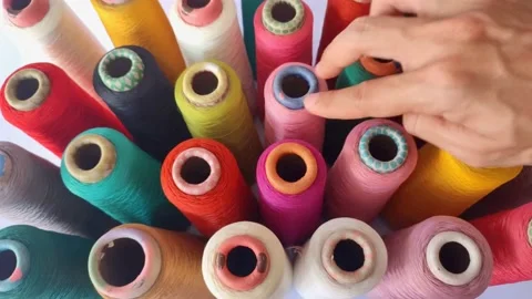 View of a man's hand picking up a spool of Thread Stock Footage 225183147