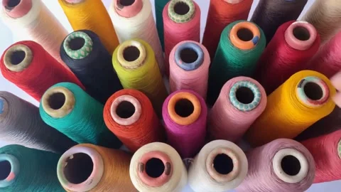 View of a man's hand putting down  a spool of Thread Stock Footage 225183395