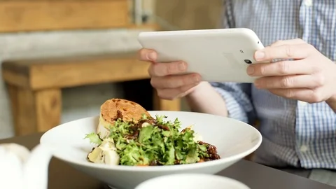 View of man's hands holding tablet and doing photos of healthy food, steadycam  Stock-Footage 72786477