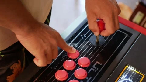 View to man's hands while holding game conrtrol panel for playing 70's game.. Stock Footage 283629403