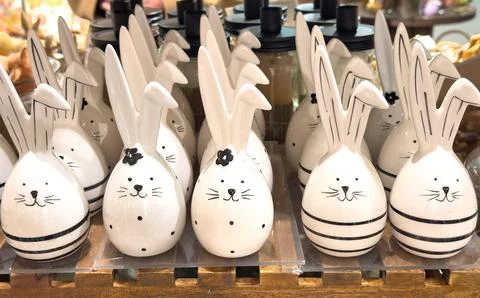 View of many decorative ceramic Easter bunnies arranged on a holiday table Stock Photos